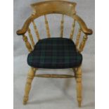 A late 19th century elm captain's armchair with plaid squab cushion. H.85cm