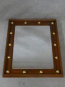 A contemporary moulded framed wall mirror with gilt roundel decoration. H.76 W.60cm