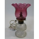 A 19th century cut crystal and cranberry glass oil lamp converted to electricity. H.38cm