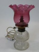 A 19th century cut crystal and cranberry glass oil lamp converted to electricity. H.38cm