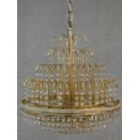 A brass framed four tier wedding cake style chandelier with crystal drops. H.50 D.43cm