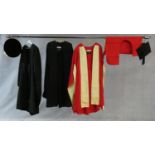 A collection of three various graduation gowns with a cap and a mortarboard, by Ede and Ravenscroft.