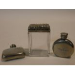 Two pewter perfume bottles with A quality mark along with a silver repousse floral design topped