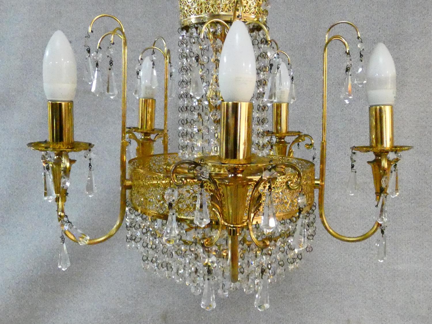 A pair of gilt metal five branch chandeliers with crystal drops. H.80 D.44cm - Image 5 of 10