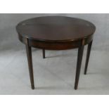 A Georgian mahogany and satinwood inlaid demi lune console tea table with foldover top and gateleg