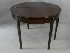 A Georgian mahogany and satinwood inlaid demi lune console tea table with foldover top and gateleg
