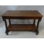 An early 19th century mahogany console table with frieze drawers and shaped and carved front