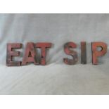 A set of six large red painted metal vintage shop front letters. One word reads' Eat' and one 'Sip'.