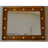 A walnut framed wall mirror with bevelled plate and gilt roundels to the frame. H.76 W.60cm