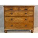 A 19th century mahogany chest of two short over three long graduating drawers on reeded bun feet.