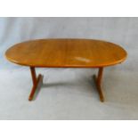 A 1960's vintage teak extending dining table on trestle style supports with extra leaf. H.72 L.167