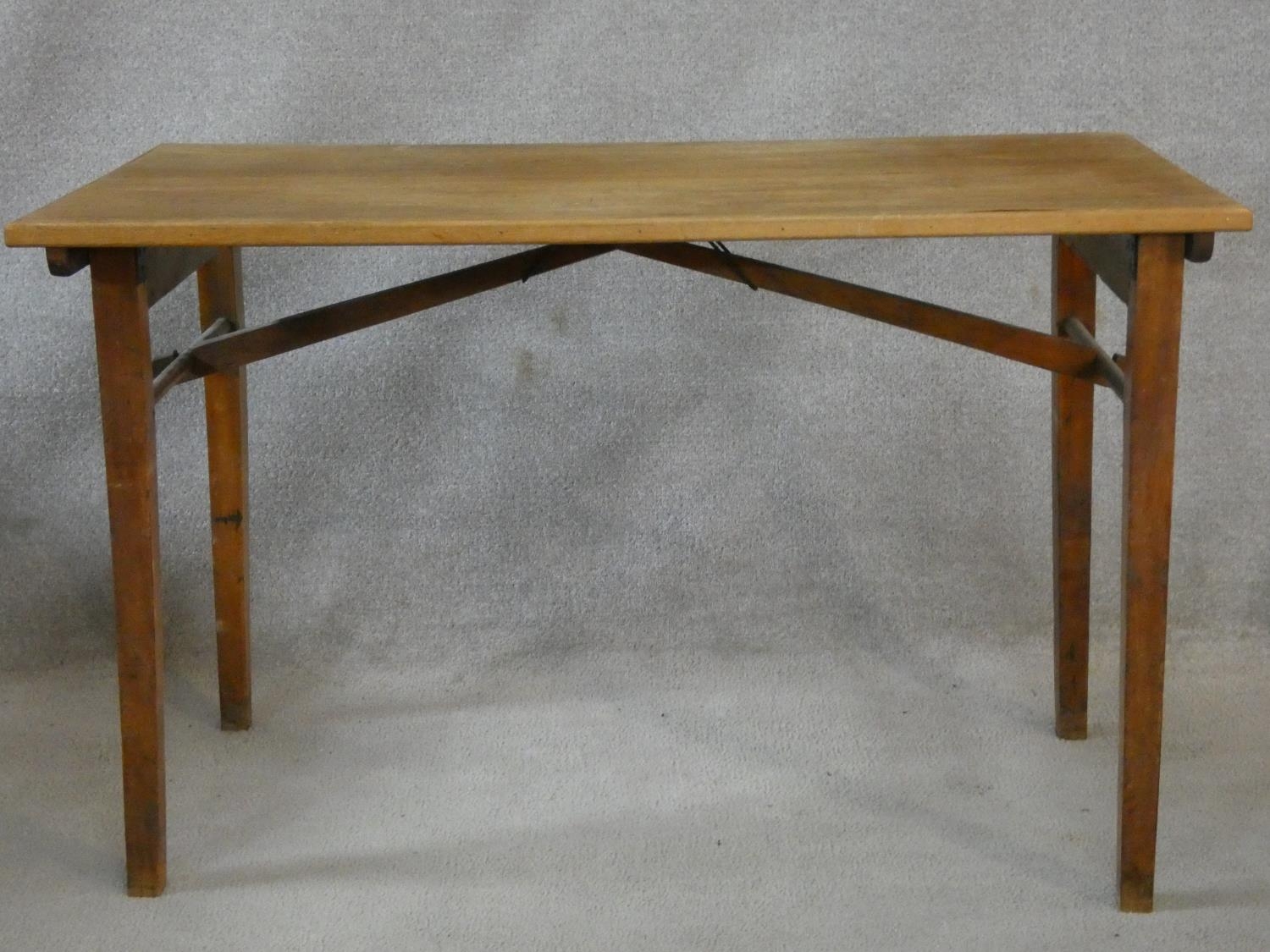 A mid century folding table, makers plaque to the underside. H.70 L.109 W.58cm