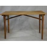 A mid century folding table, makers plaque to the underside. H.70 L.109 W.58cm