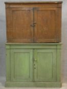 A 19th century painted pine two section bookcase with panel doors to upper and lower sections on