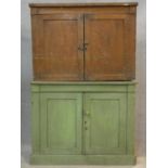 A 19th century painted pine two section bookcase with panel doors to upper and lower sections on