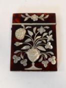 A 19th Century tortoiseshell and engraved mother of pearl inlaid card case, with a vase of flowers
