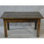 A possibly 17th century country elm low table with planked and cleated top raised on square