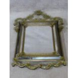 A Venetian style pier mirror with floral etched scrolling cresting and all over applied flowerhead