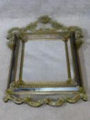 A Venetian style pier mirror with floral etched scrolling cresting and all over applied flowerhead
