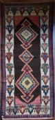 A Persian Kilim with repeating lozenge medallion on umber ground contained by plain spandrels and