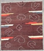 A modern Kilim with abstract design on deep burgundy ground. L.296xW.250cm