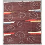 A modern Kilim with abstract design on deep burgundy ground. L.296xW.250cm