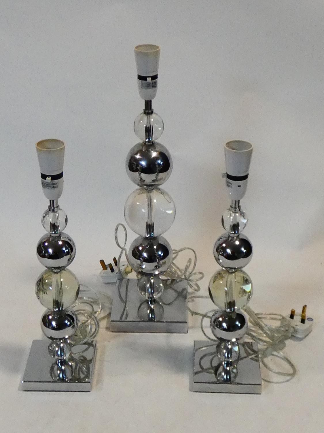 A set of three chrome and bubble glass table lamp bases. H.50cm