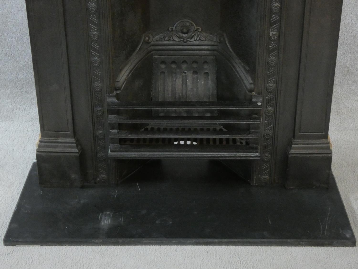 An ornately cast 19th century iron fire surround, mantel shelf and insert with grate on marble - Image 6 of 12