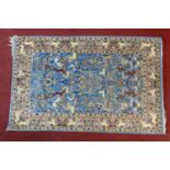 A Persian rug with all over bird, animal and foliate design on a sky blue ground contained by