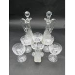 A collection of antique hand cut crystal glassware. Including two handled decanters, five