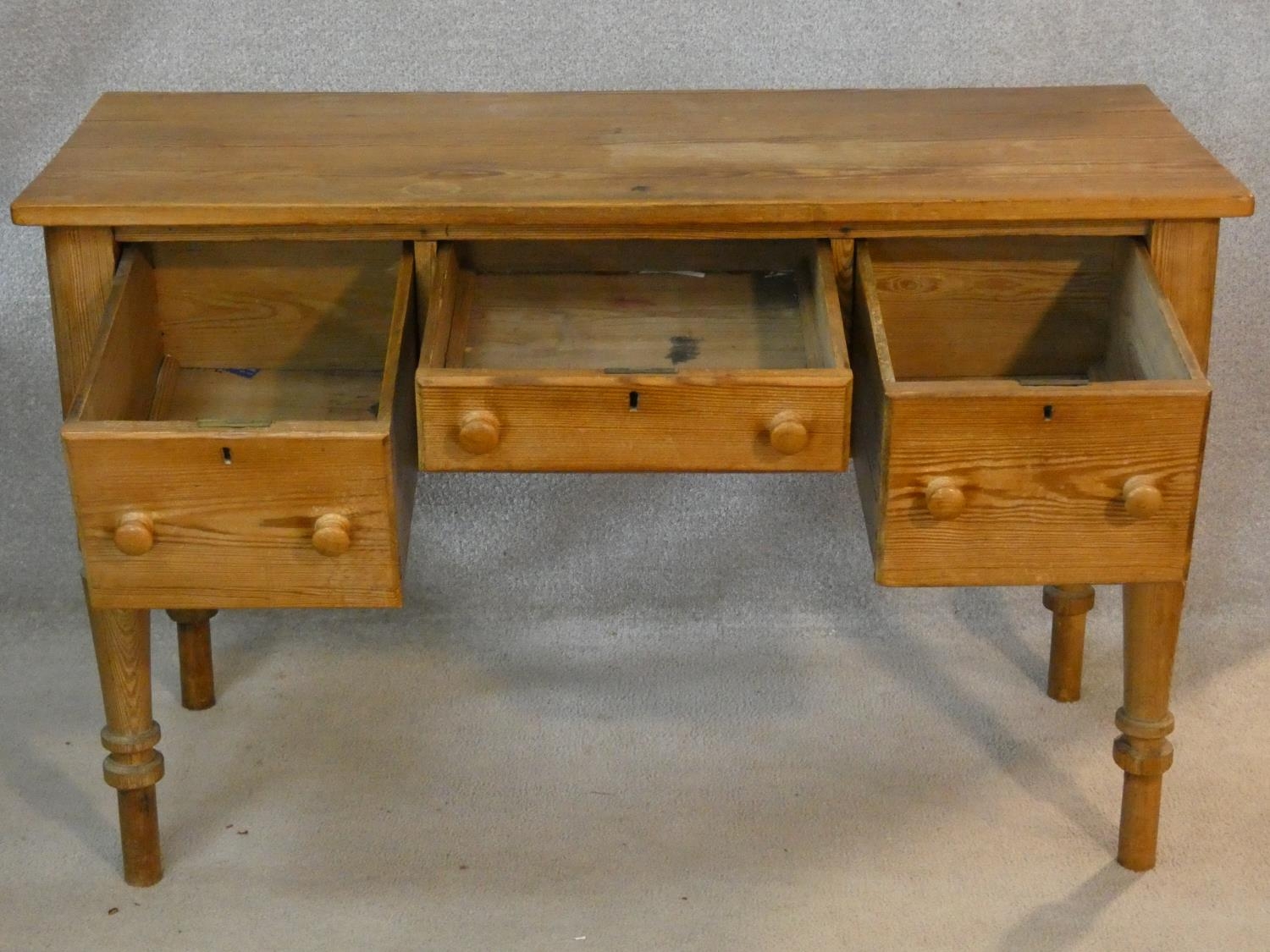 A 19th century pitch pine kneehole writing table with three frieze drawers on turned tapering - Image 2 of 5