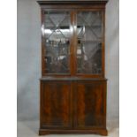 A C.1900 Georgian style library bookcase with astragal glazed doors enclosing bookshelves above