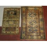 An Eastern rug with triple diamond medallions within multi borders and a similar rug with
