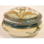 An antique hand painted and gilded porcelain lidded trinket box. The lid decorated with stylised