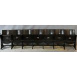 A row of seven vintage theatre seats with laminated plywood backs and seats and painted seat