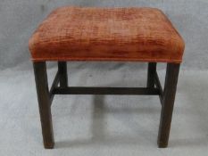 A 19th century mahogany framed stool with stuffover seat on square stretchered supports. H.47 L.52