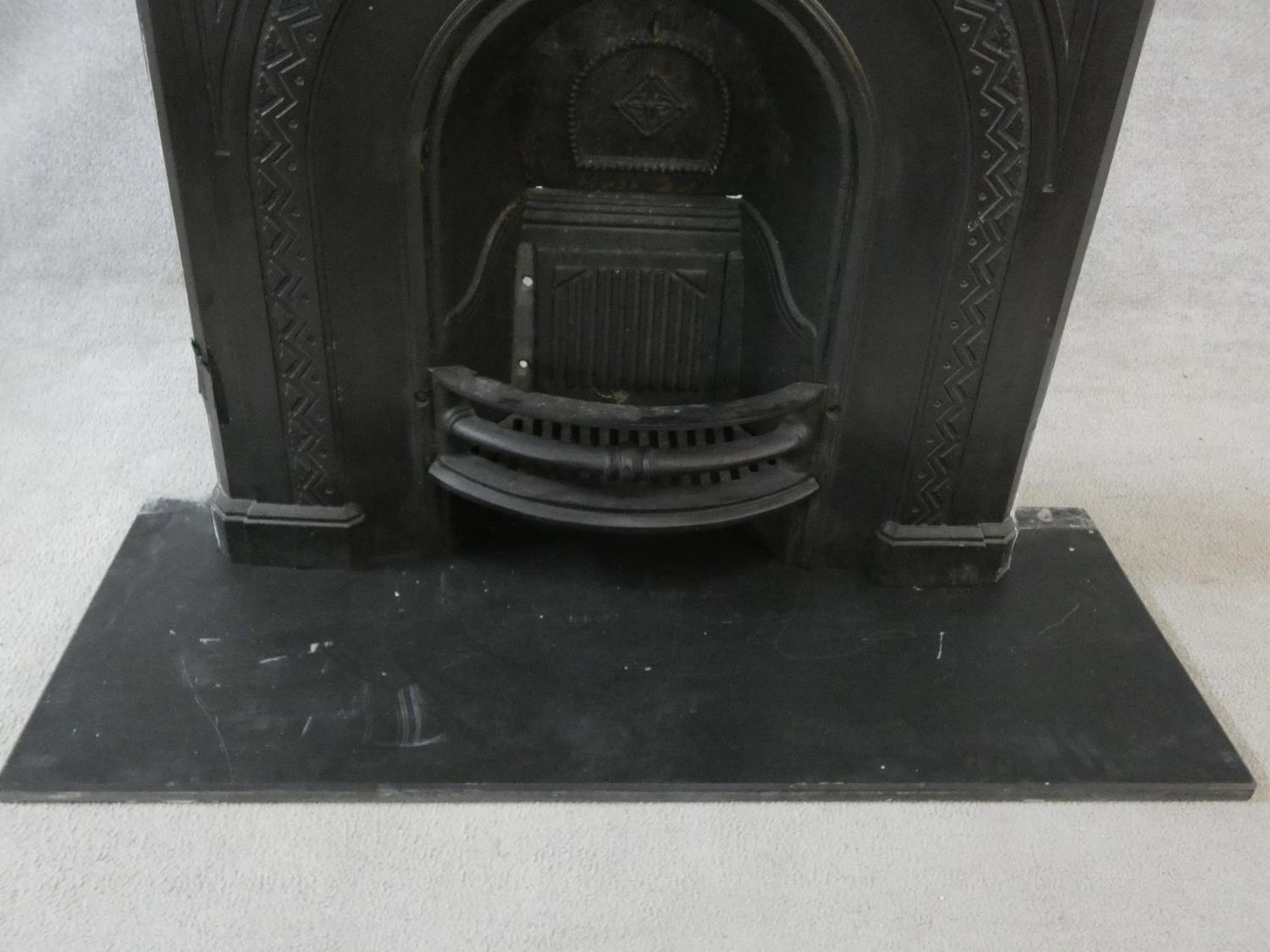 An ornately cast 19th century iron fire surround, mantel shelf and insert with grate on marble - Image 4 of 13