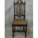 A 19th century oak antique style side chair with carved back on barleytwist stretchered supports.