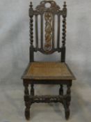 A 19th century oak antique style side chair with carved back on barleytwist stretchered supports.