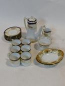 A Noritake coffee service for six with gilt and blue highlights along with a pair of floral gilt