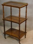 A mid 19th century rosewood and satinwood strung and inlaid three tier whatnot with brass