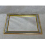 A contemporary wall mirror in glazed and gilt frame. H.70 W.90cm
