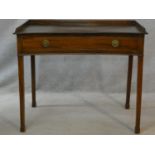 A 19th century mahogany writing table of concave outline fitted with frieze drawer on square