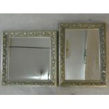 A bevelled glass wall mirror in silvered floral frame and a similar wall mirror. H.91 W.68cm (