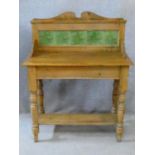 A Victorian pine washstand with Art Nouveau tiled back raised on turned stretchered supports. H.