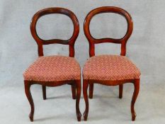 A pair of Victorian style mahogany balloon back chairs on cabriole supports. H.94cm