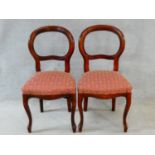 A pair of Victorian style mahogany balloon back chairs on cabriole supports. H.94cm