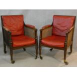 A pair of Georgian mahogany framed library bergere armchairs with leather upholstered seat and