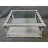 A contemporary white lacquered two tier coffee table with inset plate glass top. H.42 L.100 W.100cm