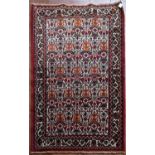 A Persian Hamadan rug with all over herati design on fawn ground within floral borders. L.100xW.